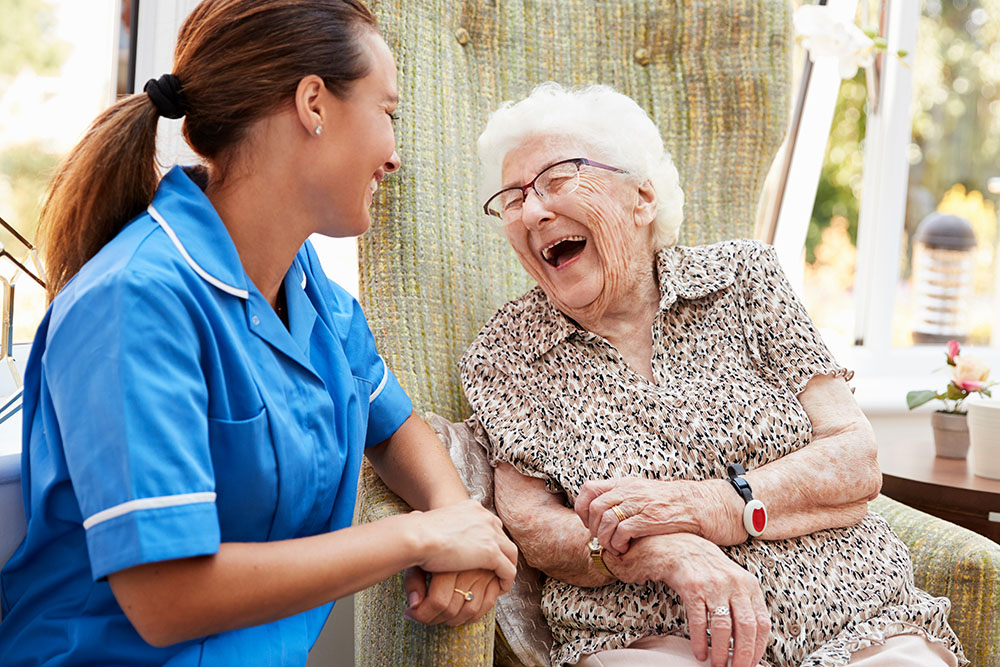 photo of laughing LTC patient and nurse
